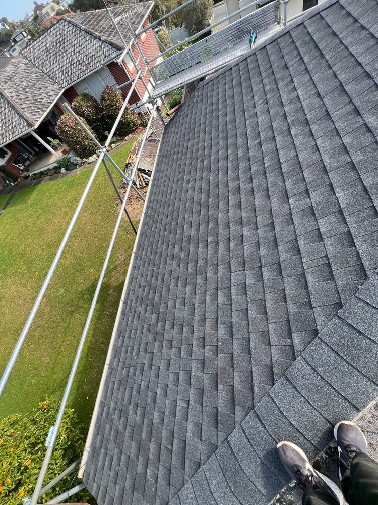 Asphalt shingle roof installation with scaffolding